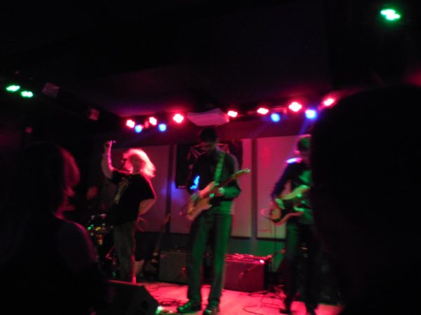 Sloe Noon on stage performing.
