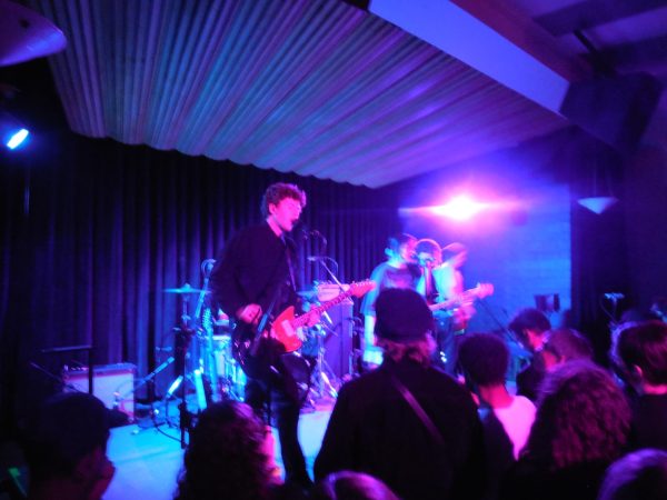 Noonan, guitarist/vocalist, singing into mic during performance